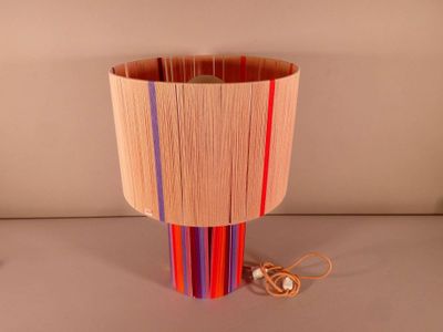 a lamp that is made out of strips of wood