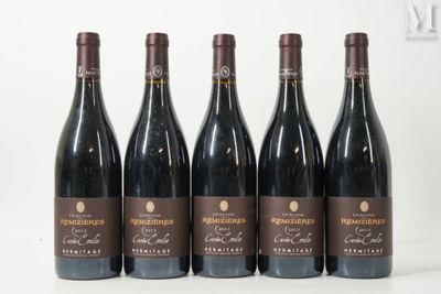 six bottles of wine are lined up on a table