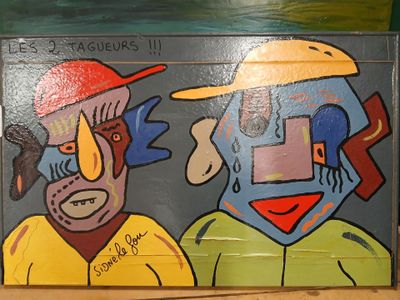 a painting on the wall of a building with a man and a woman on it