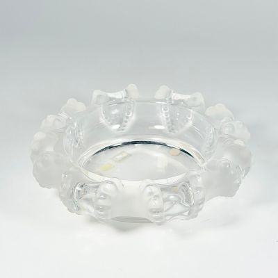 a clear glass bowl with flowers on it on a white surface