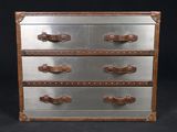 a metal chest of drawers with leather handles on it