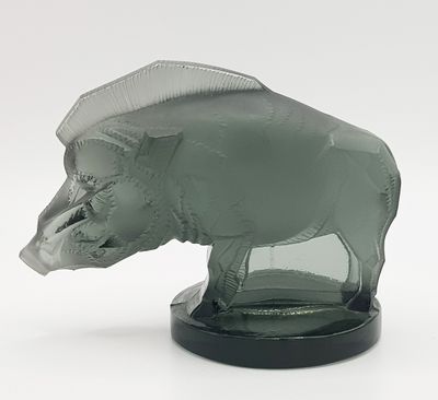 a glass sculpture of an elephant with a hat on it ' s head