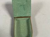 a small green box that is sitting on a table