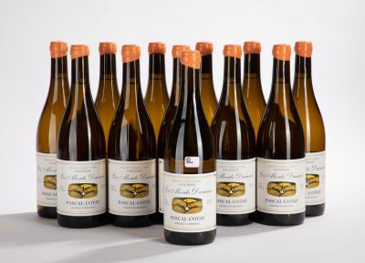 six bottles of wine are lined up in a row on a white surface