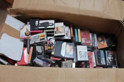 une boîte en carton remplie de DVD et de CD