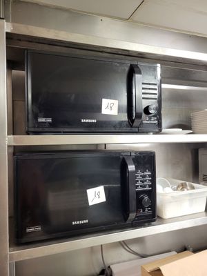 deux micro-ondes posés sur les étagères de la cuisine