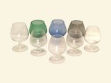 a lot of wine glasses that are lined up together