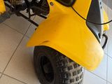 a close up of a yellow atv on a tile floor