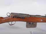 a close up of a rifle on display in a glass case