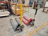 a fork lifter sitting in the middle of a warehouse floor