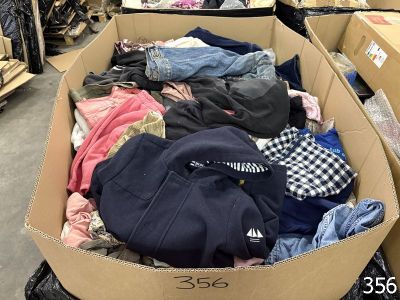 a cardboard box full of clothes in a store