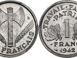 un gros plan d'une pièce de monnaie sur laquelle figure un couteau
