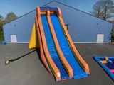 un grand toboggan aquatique gonflable au milieu d'un parking
