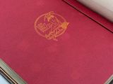 a red book with a gold logo on it