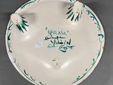 a white plate with a green and black design on it