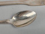two spoons and a fork on a table