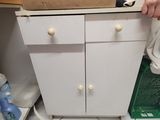 a box on top of a white cabinet in a bathroom