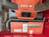 a close up of a chainsaw on a red shelf