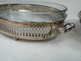 a silver plate with a bird on it next to a silver bowl