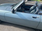 an image of a blue convertible car parked in a parking lot
