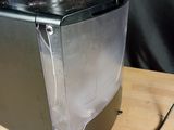 a silver microwave sitting on top of a wooden table