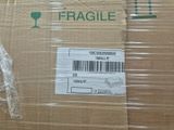a box with a fragile label on it that is wrapped in plastic