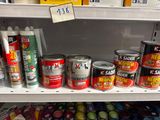 many cans of paint on a shelf in a store