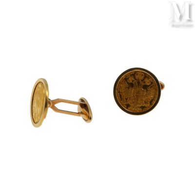 an image of a close up of a coin and a pair of cufflinks