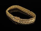 a gold bracelet on a black background