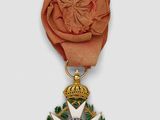 an image of a gold medal with a rose on it