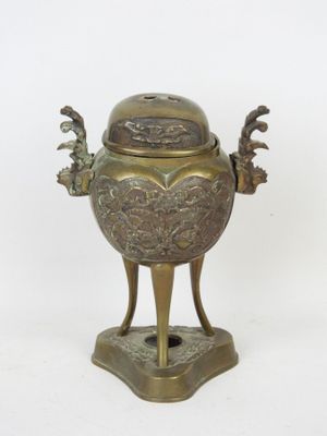 bronze incense burner on stand on white background with white background