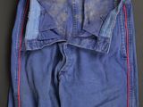 a close up of a pair of blue jeans with a red stripe on the side