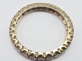 a close up of a gold ring on a white surface