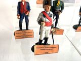 many figurines of soldiers on display in a display case