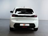 the rear end of a white car in a white room