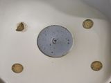 a white toilet with holes in it and a blue lid