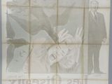 an old movie poster of a man and a woman on a bed