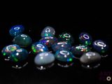 a lot of different colored stones on a black surface
