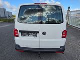 the rear end of a white van parked in a parking lot