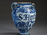 a blue and white vase with a bird on it