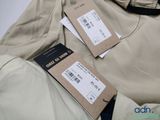 the jacket is tan and has two tags attached to it