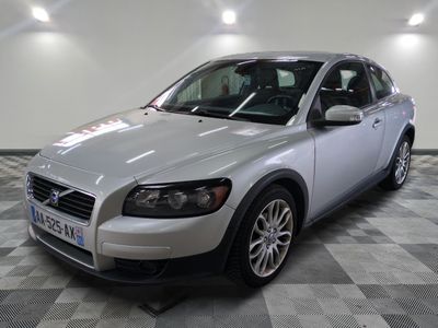 a picture of a silver volvo wagon parked in a garage