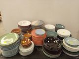 a lot of plates and bowls on the table