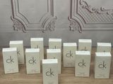 several small boxes of perfume sitting on top of a wooden table
