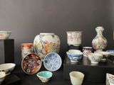 many different types of vases and bowls on the table