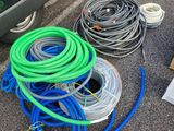 a lot of hoses on the ground next to a car