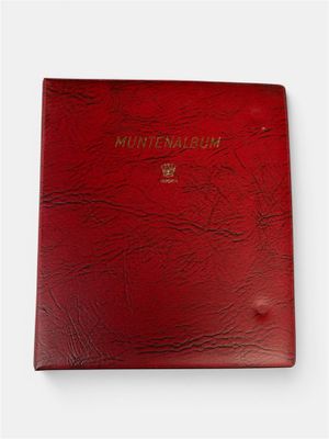 a red book with a gold logo on the cover