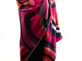 purple and pink scarf on a mannequin stand in front of a window