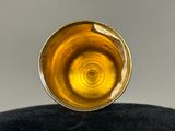 a close up picture of a glass of liquid on a black surface