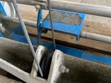 a blue machine that is sitting on a wooden floor
